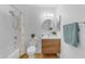 Bright bathroom featuring a wooden vanity, shower-tub combo, and updated fixtures at 5315 S River Dr, Tempe, AZ 85283