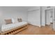 Simple bedroom with a daybed, wooden floors, and a spacious closet offers practical living space at 5315 S River Dr, Tempe, AZ 85283