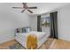 Bedroom featuring neutral tones, wood flooring, a ceiling fan, and natural light at 5315 S River Dr, Tempe, AZ 85283