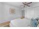 Clean bedroom featuring wood floors, light walls, a ceiling fan, and ample closet space at 5315 S River Dr, Tempe, AZ 85283
