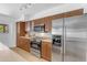 Bright kitchen with stainless steel appliances, wood cabinets, and modern fixtures at 5315 S River Dr, Tempe, AZ 85283