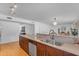 Bright kitchen featuring wood cabinets, a stainless steel dishwasher, and a double bowl sink at 5315 S River Dr, Tempe, AZ 85283