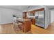 Bright kitchen with stainless steel appliances, kitchen island, and wood cabinets at 5315 S River Dr, Tempe, AZ 85283