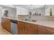 Kitchen featuring stainless steel dishwasher and sink, and cabinets with light countertops at 5315 S River Dr, Tempe, AZ 85283