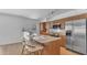 Updated kitchen with stainless steel appliances, breakfast bar and modern lighting at 5315 S River Dr, Tempe, AZ 85283