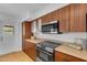 Well-lit kitchen features updated cabinets, modern appliances, and an outdoor view at 5315 S River Dr, Tempe, AZ 85283