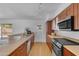 Spacious kitchen with modern appliances, wood cabinets, and access to the backyard at 5315 S River Dr, Tempe, AZ 85283