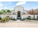 Elegant gated front entrance with desert landscaping and a charming, arched entryway leads to the home's front door at 7003 E Avenida El Alba --, Paradise Valley, AZ 85253