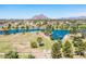 Breathtaking aerial perspective showcases the community's tranquil lake, lush green spaces, and mountain views at 8107 E Vista Dr, Scottsdale, AZ 85250