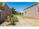 Backyard view with a path between buildings. Desert plants and a mountain in the background at 8107 E Vista Dr, Scottsdale, AZ 85250