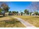 Well-maintained community grounds with lush grass, a walking path, and distant view of the community pool at 8107 E Vista Dr, Scottsdale, AZ 85250