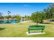 Scenic view of the community park with mature trees, a serene lake, and a comfortable bench at 8107 E Vista Dr, Scottsdale, AZ 85250