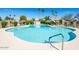 Large community pool surrounded by well-maintained landscaping and lounge furniture at 8107 E Vista Dr, Scottsdale, AZ 85250