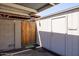 Exterior view of parking area with storage unit and wooden gate at 8107 E Vista Dr, Scottsdale, AZ 85250