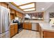 This kitchen features wood cabinets, tile floor, stainless steel appliances, and a bright window at 8107 E Vista Dr, Scottsdale, AZ 85250