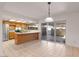 Bright kitchen with stainless steel appliances and an island. Sliding glass doors lead to the backyard at 8107 E Vista Dr, Scottsdale, AZ 85250