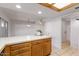Bright kitchen featuring white walls, tile floor, wood cabinets, white countertop island at 8107 E Vista Dr, Scottsdale, AZ 85250