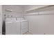 This laundry room features a washer, dryer, and wire shelving at 8107 E Vista Dr, Scottsdale, AZ 85250