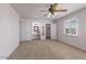 Large bedroom features a ceiling fan, neutral carpet, white walls, and closet at 8107 E Vista Dr, Scottsdale, AZ 85250