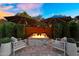 Backyard view with patio, lush greenery, and house at sunset at 10741 E Palladium Dr, Mesa, AZ 85212