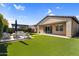 Enjoy this backyard with artificial grass, pergola, and custom hardscape at 10741 E Palladium Dr, Mesa, AZ 85212