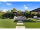 Lush backyard featuring a pergola and an outdoor seating area at 10741 E Palladium Dr, Mesa, AZ 85212