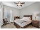 Bright bedroom boasts a ceiling fan, ample natural light, and comfortable carpet at 10741 E Palladium Dr, Mesa, AZ 85212