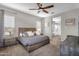 Spacious bedroom features a ceiling fan, ample natural light, and cozy carpet at 10741 E Palladium Dr, Mesa, AZ 85212