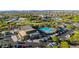 Enjoy the resort-style amenities with a large community pool, shaded seating, and palm trees enhancing the outdoor living experience at 10741 E Palladium Dr, Mesa, AZ 85212