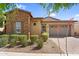 Attractive single-story home featuring stone accents, a two-car garage, and well-maintained landscaping at 10741 E Palladium Dr, Mesa, AZ 85212