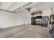 Spacious garage with epoxy flooring, storage cabinets, and ample room for parking and projects at 10741 E Palladium Dr, Mesa, AZ 85212