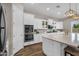 Gourmet kitchen showcasing double ovens, quartz countertops, and white cabinets for a clean, modern look at 10741 E Palladium Dr, Mesa, AZ 85212