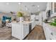 Bright, open kitchen featuring a large island, stainless steel appliances, and hardwood floors at 10741 E Palladium Dr, Mesa, AZ 85212
