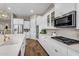 Modern kitchen boasts stainless appliances, white cabinetry, and a gas cooktop, perfect for culinary enthusiasts at 10741 E Palladium Dr, Mesa, AZ 85212