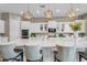A spacious island with bar stool seating complements this kitchen, featuring pendant lighting and built in oven at 10741 E Palladium Dr, Mesa, AZ 85212