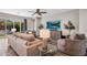 Comfortable living room with tile flooring, stylish seating, and a sliding door to the patio at 10741 E Palladium Dr, Mesa, AZ 85212