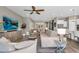Spacious living room featuring neutral tones, tile flooring, and an open layout leading to the kitchen at 10741 E Palladium Dr, Mesa, AZ 85212