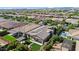 Aerial view of home showcasing outdoor living with pergola, artificial lawn, and lush backyard landscaping at 10741 E Palladium Dr, Mesa, AZ 85212