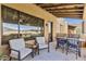 Inviting balcony with chairs, a table, and views of the surrounding desert landscape at 13450 E Via Linda -- # 2041, Scottsdale, AZ 85259