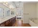 Spacious bathroom with double sinks, a soaking tub, and views into an adjacent bedroom at 13450 E Via Linda -- # 2041, Scottsdale, AZ 85259