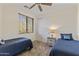 Comfortable twin bedroom with neutral walls, a ceiling fan, and views of the neighborhood at 13450 E Via Linda -- # 2041, Scottsdale, AZ 85259