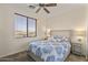 Cozy bedroom with soft lighting, a patterned bedspread, and a large window, creating a peaceful ambiance at 13450 E Via Linda -- # 2041, Scottsdale, AZ 85259