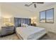 Serene bedroom with a tufted headboard, soft lighting, and a large window, creating a relaxing retreat at 13450 E Via Linda -- # 2041, Scottsdale, AZ 85259