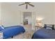 Twin bedroom featuring two beds, a ceiling fan, and French doors, offering a tranquil retreat at 13450 E Via Linda -- # 2041, Scottsdale, AZ 85259