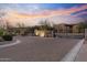 Wide view of the community entrance highlighting the signage and desert landscaping at sunset at 13450 E Via Linda -- # 2041, Scottsdale, AZ 85259