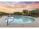 Beautiful community pool and spa area at sunset, surrounded by lush landscaping and lounge chairs at 13450 E Via Linda -- # 2041, Scottsdale, AZ 85259