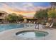 Resort-style community pool with a hot tub, lounge chairs, and desert landscaping at 13450 E Via Linda -- # 2041, Scottsdale, AZ 85259