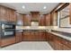 Modern kitchen with dark wood cabinets, granite countertops, and stainless steel appliances at 13450 E Via Linda -- # 2041, Scottsdale, AZ 85259