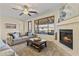 Comfortable living room featuring a fireplace, neutral sofa, and large windows offering natural light at 13450 E Via Linda -- # 2041, Scottsdale, AZ 85259