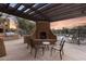 A community patio with a fireplace, grill, and comfortable seating offer inviting spaces for relaxation near the pool at 13450 E Via Linda -- # 2041, Scottsdale, AZ 85259